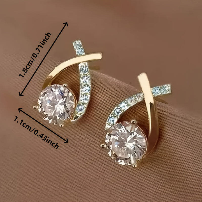 Stud earrings with golden cross and zirconia